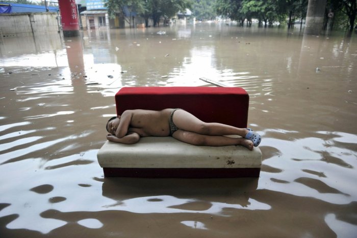 and-flooding-isnt-limited-to-the-us-either-here-a-child-sleeps-in-the-middle-of-a-flooded-street-in-chinas-chongqing-municipality-during-a-2010-outbreak-of-torrential-rain-which-killed-dozens-of-people